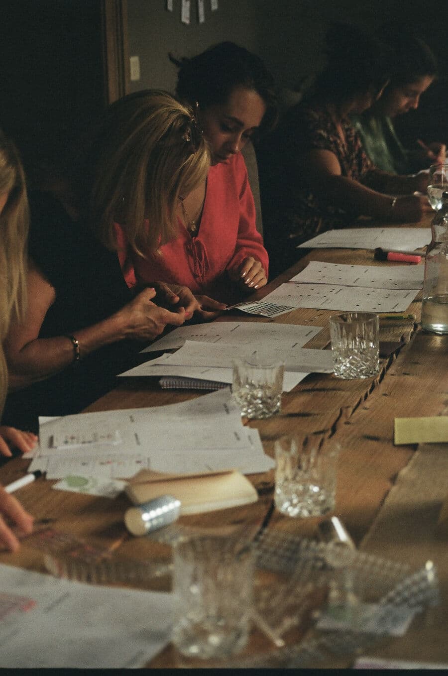 Hands peeling a sheet of tiny stickers onto an agenda page