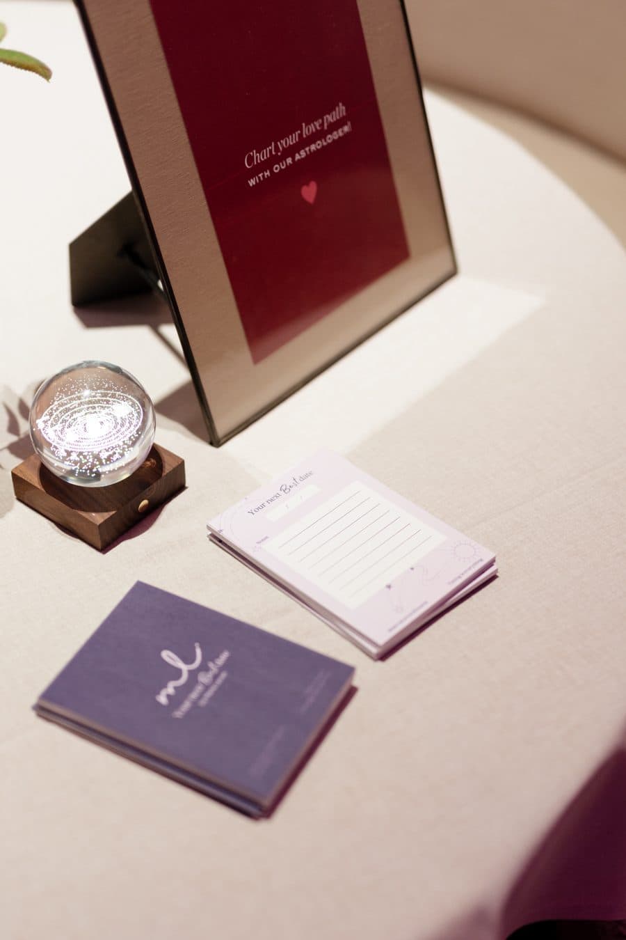 The consult table: a Chart your love path sign, a crystal sphere and date cards
