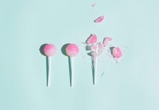 Two intact lollipops next to a shattered one