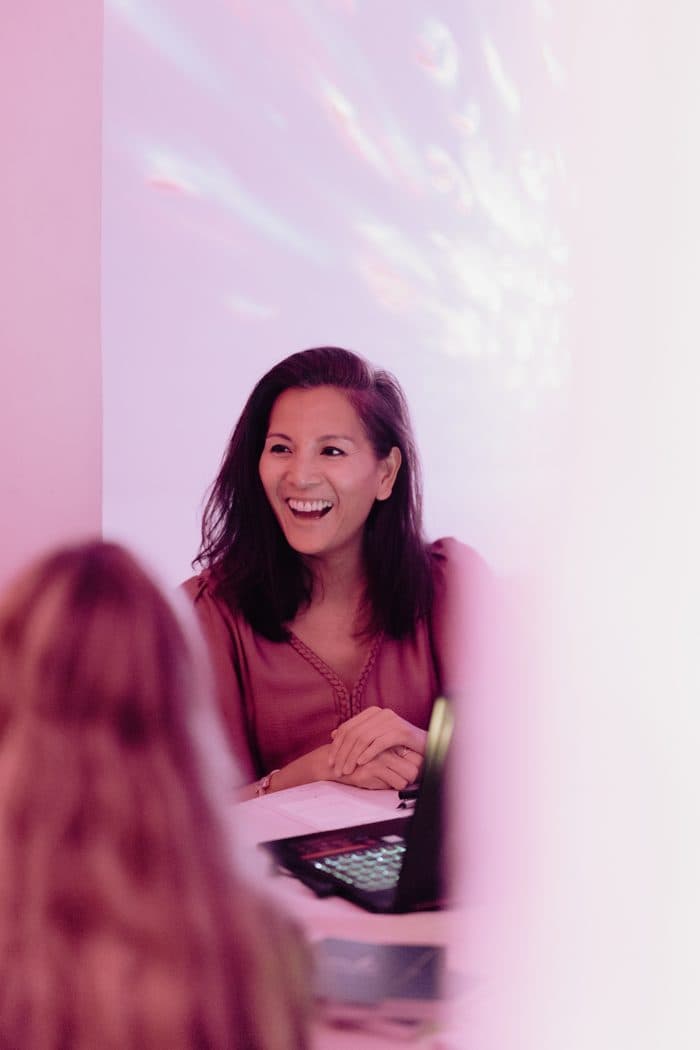 Marie-Ange laughing, in pink light